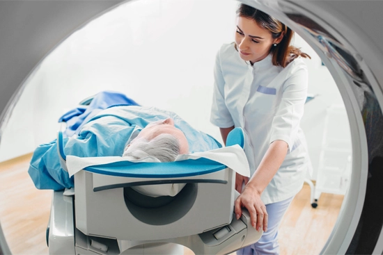 imaging tech talking with patient about to get an MRI