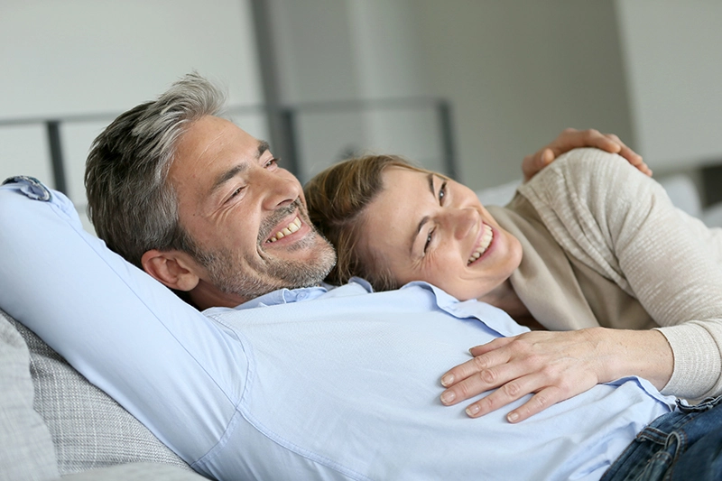 couple cuddling on a sofa